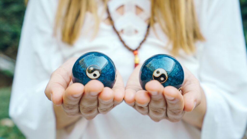 Attracting Love: Feng Shui Tips for Singles 4 Chinese balls Yin Yan in hand balance, natural healing concept