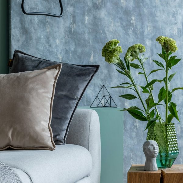 Stylish composition of cozy living room with sofa.